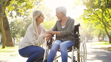 Image showing Happy, wheelchair and a mother and woman in a park for support, bonding and talking. Smile, family love and an elderly mom with a disability and a girl in nature for conversation and happiness