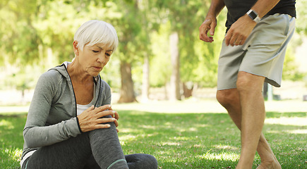 Image showing Old couple, woman with knee pain and injury outdoor, fibromyalgia health problem and joint ache from exercise. Muscle tension, arthritis and people in retirement with fitness in park and emergency