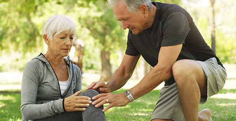Image showing Old couple, woman with knee pain and injury in park, fibromyalgia health problem and joint ache from exercise. Man helping, arthritis and people in retirement with fitness outdoor and muscle tension