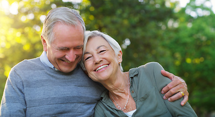 Image showing Laughing, love and senior couple in a park together hugging with care, happiness and romance. Smile, nature and elderly man and woman in retirement embracing while sitting in an outdoor green garden.