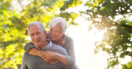 Image showing Senior couple, piggy back and happy outdoor at a park with love, care and support. A elderly man and woman in nature for a fun walk, quality time and healthy marriage or retirement while playful