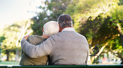 Image showing Hug, bench and a senior couple outdoor in a park with love, care and support in marriage. Back of elderly man and woman together in nature for quality time, healthy retirement and freedom to relax