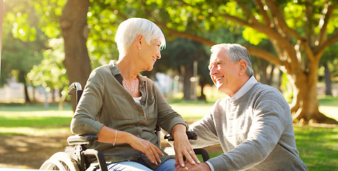 Image showing Senior couple, wheelchair and happy outdoor at a park while talking with love, care and respect. A elderly man and woman with disability in nature for quality time, healthy marriage or retirement