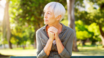 Image showing Tired, thinking and a sad woman in a park with depression, mental health problem and anxiety. Ideas, praying and a senior person sitting in nature with a prayer, hope and thoughtful while depressed