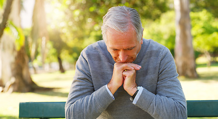 Image showing Stress, thinking and senior man in a park sitting on a bench with a contemplating face and hand gesture. Nature, outdoor and elderly male person in retirement in a garden with a thoughtful expression