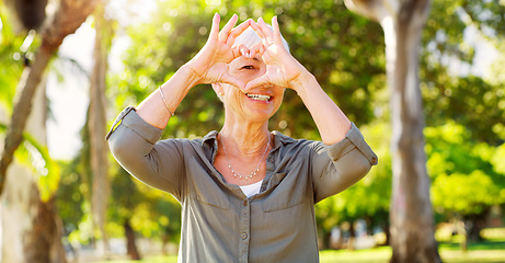 Image showing Portrait, heart hands and a woman in a park for summer, retirement break and calm in Australia. Happy, care and a senior person with a shape gesture to show love, happiness and support in nature