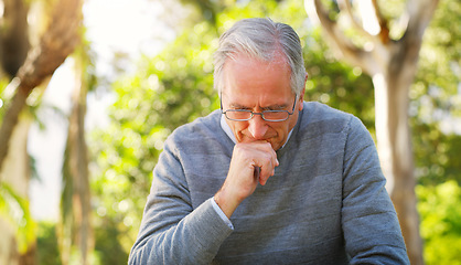 Image showing Depression, park and senior man crying while sitting on a bench thinking on mental health problem. Nature, outdoor and sad elderly male person in retirement with grief stress after loss in a garden.