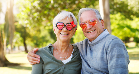 Image showing Senior couple, funny glasses and portrait outdoor at a park with love, care and heart shape. A elderly man and woman with comic sunglasses in nature for happiness, healthy marriage and retirement