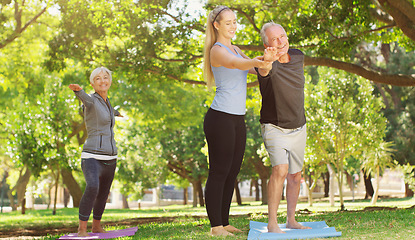 Image showing Yoga, wellness and an old couple with their personal trainer in a park for a health or active lifestyle. Exercise, fitness or zen and senior people outdoor for a workout with their pilates coach