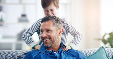 Image showing Love, father and son happy smile in living room of their home with lens flare. Happiness or caring, family and male parent with child playing spending quality time or bonding together on couch