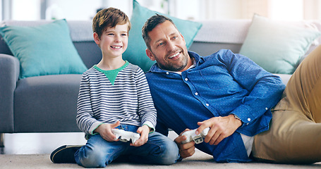 Image showing Happy father, child and playing video games for fun bonding, holiday or weekend together on the living room floor at home. Dad and kid smiling in joyful happiness for console gaming or entertainment