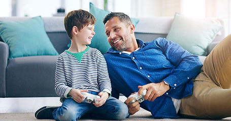 Image showing Father, child and playing video games for fun bonding, laughing or time together on living room floor at home. Happy dad and kid smiling with laugh for funny family, son or gaming entertainment