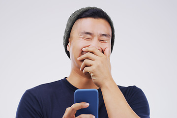 Image showing Smile, funny and Asian man with a smartphone, connection or happiness against grey studio background. Male person, happy or guy with a cellphone, mobile app and meme with social media, humor or comic