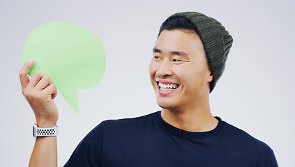 Image showing Young asian man, speech bubble and studio with smile, opinion and social media with by background. Gen z guy, poster or paper sign for vote, review or mockup with happiness for ideas, news or chat