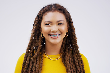 Image showing Happy, smile and portrait of a woman with braces isolated on a white background in a studio. Happiness, confident and a face headshot of a young girl with dreadlocks, confidence and positivity