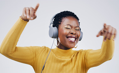 Image showing Dance, happy and a black woman with music on headphones isolated on a white background in studio. Smile, crazy and an African girl listening to audio, dancing and streaming radio for happiness