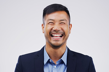 Image showing Happy, laughing and portrait of businessman in a studio with comedy, comic joke or funny story. Happiness, smile and face of an Asian male person with a positive face expression by gray background.