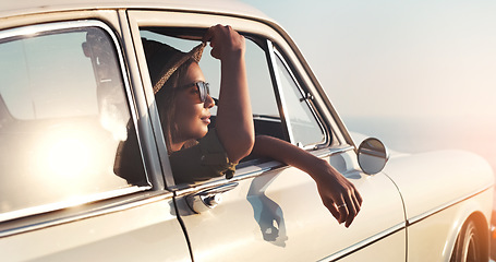 Image showing Road trip, window and flare with a woman in a car for travel, freedom or ride as a tourist on a coast in summer. Nature, sunset or vacation with a female traveler taking a drive outdoor for adventure