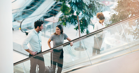 Image showing Escalator, business people and staff talking, discussion and happiness with ideas, planning or chatting. Man, woman or coworkers in a modern office, conversation or communication on a moving stairway