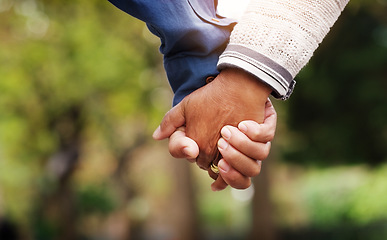 Image showing Love, closeup senior couple holding hands and in a park nature background. Support or care, bonding or quality time and married old people outdoors together in a garden or in green environment.