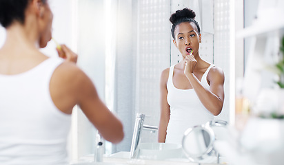 Image showing Woman brushing teeth in bathroom, mirror with dental and oral hygiene with morning routine, toothbrush and health. Female person at home, grooming and self care with clean mouth and wellness