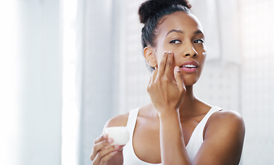 Image showing Woman, face and mirror with cream for beauty, moisturizer and cosmetic product with morning routine in bathroom. Female person apply lotion to skin, skincare and dermatology at home with mockup space