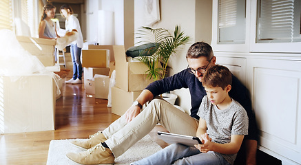 Image showing Father, son and tablet, playing games and relax, break from unpacking and moving into new house. Man, boy and wireless tech with property, real estate and rest with video game online and bonding