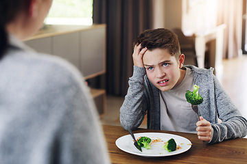 Image showing Disgust, food and child with vegetables in home for nutrition, health and cooking. Lunch, angry and dinner with boy and refuse to eat broccoli at tablet for eating problem, frustrated and dislike