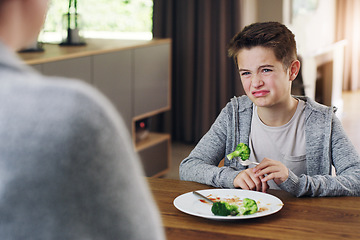 Image showing Disgust, vegetable and fear with child and broccoli for nutrition, health and cooking. Sad, angry and dinner with boy and refuse to eat food at home for eating problem, frustrated and dislike