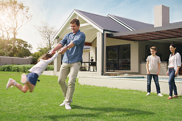 Image showing Happy family, real estate and playing on grass together from holiday, weekend or break in the outdoors. Father swinging child on new home, lawn or property for fun time or play outside the house