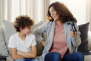 Image showing Mother, boy and controller on couch for gaming with loser, competition and contest with laughing in house. Mom, young son and online games on living room couch with upset face for loss in family home