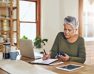 Image showing Senior woman, budget planning and health insurance checklist with phone at home. Writing, contract and elderly female person with financial, tax and pension form in a house with bills and debt