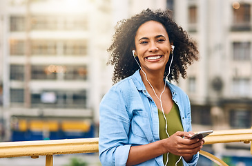 Image showing Phone, music and portrait of woman in city with happiness listening to track, audio and song in urban town. Traveling, happy and African female person streaming radio for relaxing, chill and peace