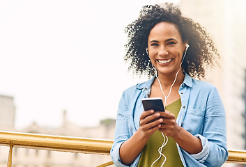 Image showing Happy, music and portrait of woman in city with phone listening to track, audio and mockup in urban town. Traveling, smile and beautiful African female person streaming radio for relaxing on weekend