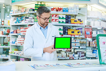 Image showing Man, pharmacist and tablet with green screen with healthcare, store and mockup with pharmaceutical promo on app. Mature pharma expert, digital touchscreen and space with chromakey for mock up in shop