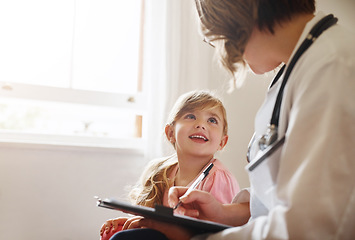 Image showing Child doctor, girl and talking trust with medical checklist in a hospital for wellness and health. Happiness, clinic consultant and pediatrician with healthcare and appointment with a kid form