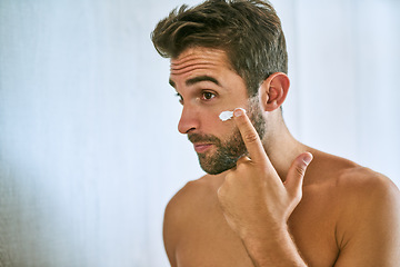 Image showing Man, face and cream for skincare, beauty and sunscreen at home with mockup for morning routine, grooming and self care. Young guy, lotion and facial cosmetics for dermatology, clean skin and hygiene