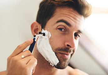 Image showing Portrait, man and shaving face with razor for hair removal, aesthetic skincare and morning facial cleaning at home. Closeup of guy, foam and and shave with cream cosmetics, blade or beard in bathroom