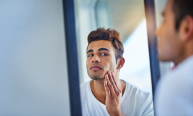 Image showing Skincare, man looking in a mirror and face in bathroom with lens flare. Body treatment or cosmetics for wellness, dermatology or skin routine and facial care with male person at home in morning