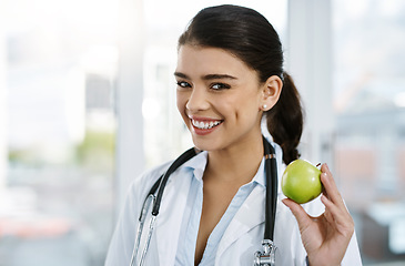 Image showing Doctor, portrait and happy woman with apple for nutrition, healthy diet or wellness. Face, nutritionist or medical professional with fruit for advice, healthcare or natural food for vegan benefits