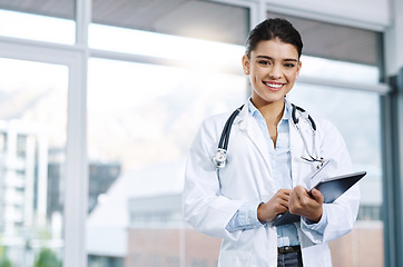 Image showing Portrait, doctor and happy woman with tablet in hospital for research, telehealth or healthcare. Face, smile and female medical professional with touchscreen tech for online wellness in clinic.