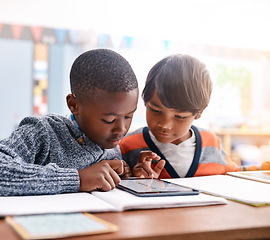 Image showing Tablet, school and boy students in classroom doing research while studying for test or exam. Technology, education and children friends working on project or assignment together with mobile on campus