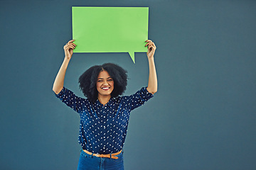 Image showing Mockup, poster and woman portrait with speech bubble in studio for news or social media blue background. Space, voice and female person advertising opinion with paper, sticker and branding promotion