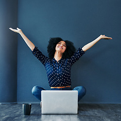 Image showing Laptop, achievement and woman in celebration on the floor by a blue wall for good news or success. Happy, smile and excited professional female employee with job promotion to celebrate with computer.