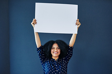 Image showing Paper, mockup and portrait of happy woman in studio with banner for news, social media or advertising on blue background. Space, billboard and female smile with poster, sticker and branding promotion