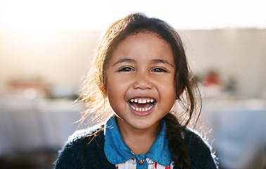 Image showing Happy kid, face and girl laughing in living room, playing and having fun in her home. Child, development and portrait of Mexican female toddler with funny, joke or reaction to crazy comedy in a house