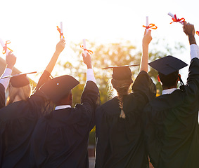 Image showing Group, students and graduation diploma of college or university friends together from behind. Men and women outdoor to celebrate education achievement, success or certificate in hands at school event