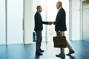 Image showing Handshake, partnership and travel for business men in office for onboarding, collaboration and agreement. Corporate, teamwork and male lawyers shaking hands for thank you, welcome and contract deal