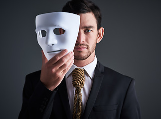 Image showing Two faced portrait, mask and fake businessman in a studio with serious face with secret personality. Manager and corporate male with rope tie showing corporate slavery and control in business suit