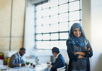 Image showing Muslim, business woman and portrait in office with a smile, hijab and arms crossed for career pride. Arab female entrepreneur or leader at a corporate workplace with a positive mindset and motivation